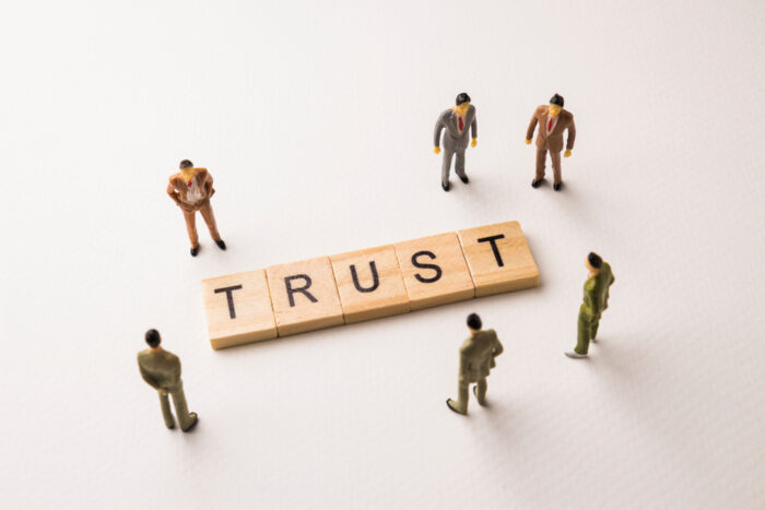 People standing around the word trust